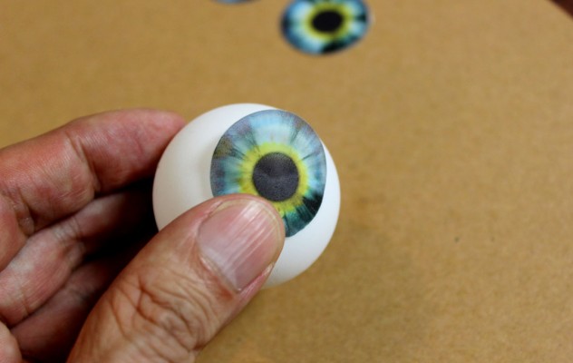 Peel off the protective backing and press the image onto the ping pong ball.